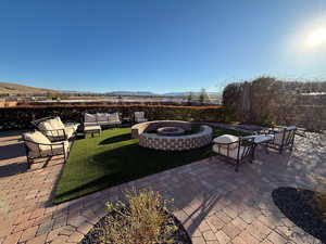 View of patio / terrace featuring a mountain view and an outdoor living space with a fire pit