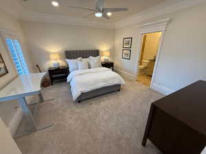 Bedroom with crown molding, carpet floors, recessed lighting, ceiling fan, and ensuite bath