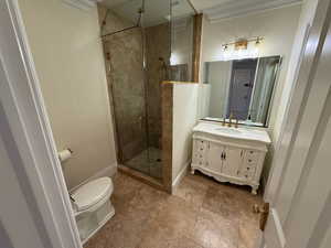 Bathroom featuring vanity, a stall shower, and ornamental molding
