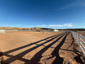 View of yard with an enclosed riding area and a view of countryside