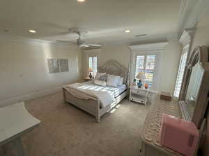 Bedroom featuring ornamental molding, light carpet, multiple windows, recessed lighting, and ceiling fan