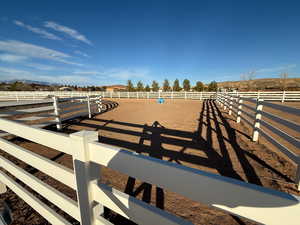 View of home's community with an outdoor riding arena and a rural view