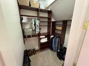 Walk in closet with vaulted ceiling