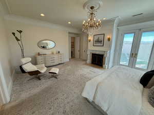 Bedroom with french doors, access to exterior, a chandelier, ornamental molding, and recessed lighting