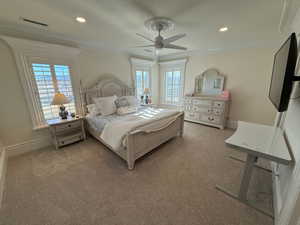 Bedroom featuring carpet flooring, multiple windows, recessed lighting, ornamental molding, and a ceiling fan