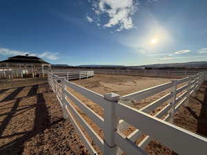 View of yard featuring an enclosed riding area and a view of rural / pastoral area
