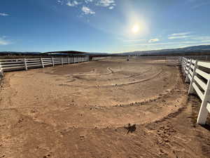 View of yard with an outdoor riding arena and a view of rural / pastoral area