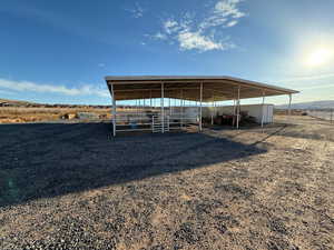 View of outbuilding with a detached carport and a rural view