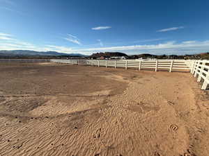 View of yard featuring an enclosed horse arena and a mountain view