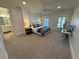 Bedroom with ornamental molding, light colored carpet, recessed lighting, a ceiling fan, and ensuite bathroom