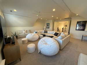 Living area with light carpet, ceiling fan, crown molding, and recessed lighting