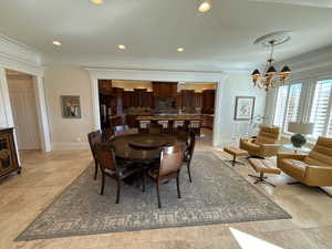 Dining room featuring a chandelier, crown molding, and recessed lighting