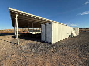 View of outbuilding featuring a carport