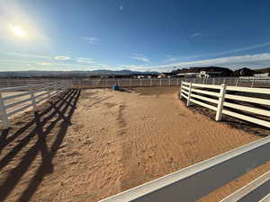 View of yard with an enclosed riding area and a mountain view