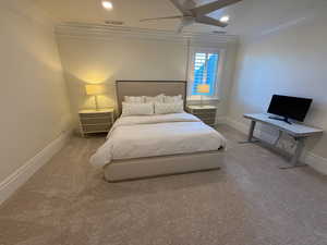 Carpeted bedroom featuring crown molding, recessed lighting, and ceiling fan