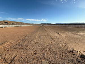 View of road with an enclosed horse arena and a view of countryside