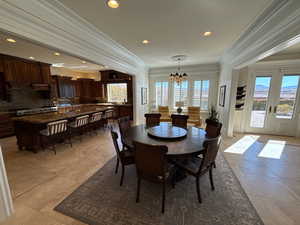 Dining space with crown molding, a chandelier, and recessed lighting
