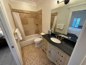 Bathroom featuring ornamental molding, ensuite bathroom, vanity, and shower / bathtub combination with curtain