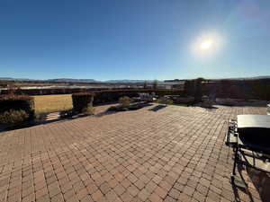 View of patio with a mountain view and area for grilling