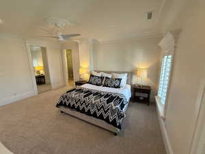 Bedroom featuring carpet, crown molding, and a ceiling fan