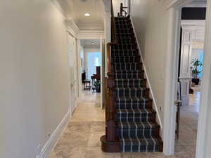 Stairway with crown molding, recessed lighting, and tile patterned flooring