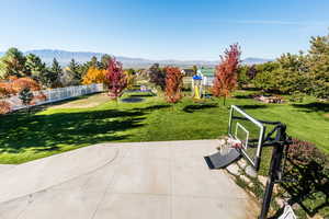 View of patio with a mountain view and a playground