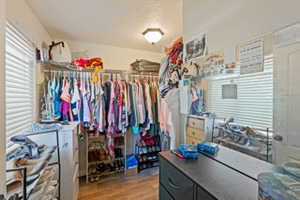 Walk in closet with wood finished floors