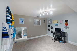 Office featuring a textured ceiling and carpet