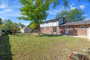 Fenced backyard with a storage unit, a patio area, entry steps, and outdoor lounge area
