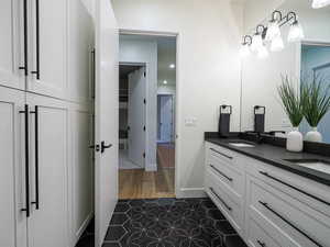 Full bath with tile patterned flooring and double vanity