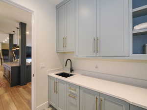 Kitchen featuring light countertops, gray cabinetry, and light wood-type flooring