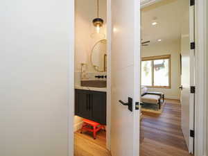 Hall featuring wood finished floors and recessed lighting