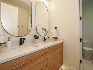 Full bathroom with double vanity and tile patterned flooring