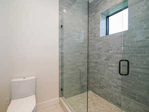 Bathroom featuring a stall shower and tile patterned flooring
