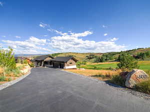 View of front facade featuring a garage, driveway, and a mountain view