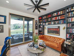 Living room featuring wood finished floors, recessed lighting, and ceiling fan