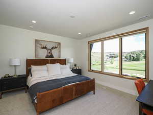 Bedroom with light carpet and recessed lighting