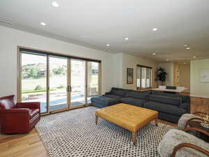 Living room featuring light wood-type flooring and recessed lighting