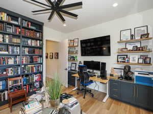 Office area featuring light wood-type flooring, a ceiling fan, and recessed lighting