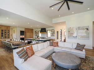 Living area featuring light wood-style floors, recessed lighting, ceiling fan, and a chandelier