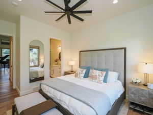 Bedroom featuring wood finished floors, recessed lighting, ensuite bath, and ceiling fan