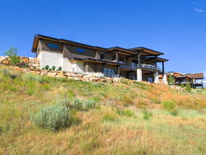 Back of property featuring stone siding