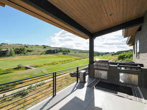 Patio / terrace featuring an outdoor kitchen and golf course view