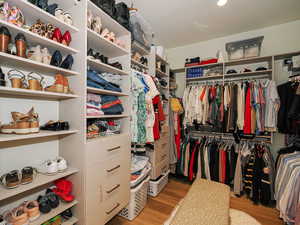 Walk in closet featuring wood finished floors