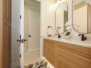 Full bath featuring double vanity