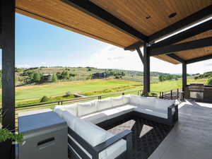 View of patio featuring an outdoor hangout area, view of golf course, and an outdoor kitchen