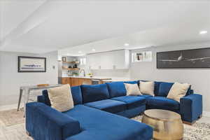 Living room featuring recessed lighting and bar with sink