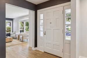 Foyer entrance with light wood-type flooring