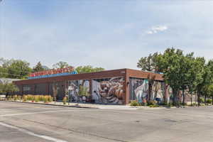 View of building exterior with uncovered parking