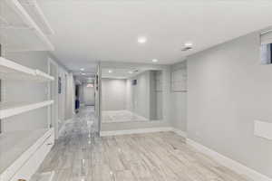 Hall featuring recessed lighting and baseboards